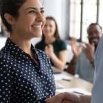 Employee appreciation day header image of employee shaking hands with boss