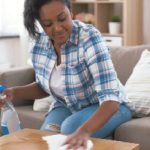 woman spring cleaning her coffee table